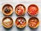 Top view of various appetizer in ceramic bowls