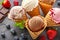 Top view of various assortment of waffle cone ice cream flavor\\\'s setup on dark stone background