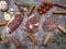 Top view of various cuts of raw meat steak with herbs on grey concrete background. food preparation concept.