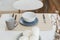 Top view of various dishware on the white dinner table - ceramic plates, cup, fork, spoon and knive