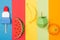 Top view of various origami fruits and ice cream on colorful paper stripes.