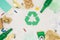 top view of various types of trash surrounding recycle sign