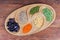 Top view of various uncooked legumes on wooden serving dish