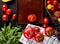 top view of vegetables as tomato basil in basket and cut tomato in tray with green mint leaves on wooden background