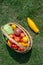 Top view vegetables in a wicker basket in the garden on the green grass. Fresh organic vegetables harvest: Various