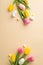 Top view vertical photo of colorful easter eggs ceramic easter bunny yellow and pink tulips