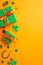 Top view vertical photo of green gift boxes with orange bows trefoils shamrock shaped confetti horseshoe and gold coins