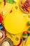 Top view vertical photo of yellow circle tequila nacho chips with sauce chilli lime sombrero serape garland maracas