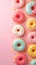 Top view of vibrant donuts colorful delights with sprinkles on pink