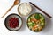 Top view Vietnamese vegan cuisine, family meal, vegetables sour soup, fried peanut with soy sauce and rice bowl for lunch