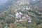 Top view of a village in hill state Himachal, India. Step fields and lush green landscape is clearly visible in the shot