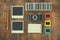 Top view of vintage camera and old slides frames over wooden table background