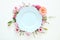 Top view of vintage white empty plate over spring flowers. Flat lay.