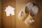 Top view of warm woman slippers over wooden floor and paper house shape as welcome home concept