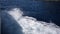 Top view of wave foam and bubbles on sea water surface for travel while sailing. Wake behind large passenger ferry at