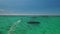 Top view of the white beach and turquoise waters of the Indian ocean near Le Morne Brabant, Mauritius.