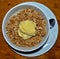 Top view of white bowl on table filled with tasty oats prepared by chef with vanilla ice cream on top, gread dessert ideas that