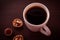 Top view of a white Cup with black coffee, a walnut and one sweet candy with hazelnut