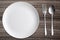 Top view White dish spoon fork on wood background