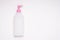 Top view white empty plastic cleaning product bottle with pink lid and dispenser on white background for branding