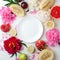 Top view of white empty plate, fruit and flowers. Flat lay, spring summer season holiday, femenine wedding table setting,