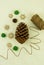 Top view of the white knitted background with elements of New Year`s decor. a large cone of cedar, carved wooden snowflakes, craf