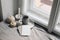 Top view of white little pumpkins, cup of coffee and smoking candle near window. Blank greeting card mockup. Autumn