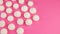 Top View of White Mini Marshmallows on Pink Background with Copyspace.