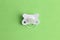 Top view of white pacifier on green background