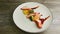 Top view on white plate with decorated baked chicken and broccoli pieces