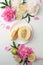 Top view of white plate with melon, spring flowers. Flat lay, spring summer season holiday, femenine wedding table setting,