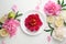 Top view of white plate over spring flowers. Flat lay, spring summer season holiday, femenine wedding table setting, valentine,
