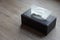 Top view white tissues in a rectangular black leather box placed on bedding background, object, decor, modern, copy space