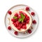 Top view of a whole raspberry cheesecake on a plate.