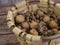 top view of wicker basket with nuts: walnuts and hazelnuts. wooden background