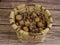 top view of wicker basket with nuts: walnuts and hazelnuts. wooden background