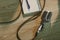 top view of wired vintage microphone lying on wooden table