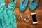 Top view of woman accessories collection over wooden background