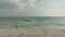 Top view of woman in a bikini runs along the beach. Aerial view of slim lady near the ocean on her vacation