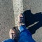 Top view of woman boots with shadows. Woman walking on the street