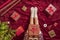 Top view of woman with christmas gift box on knees. Female wrapping gifts for family sitting on fluffy plaid near christmas tree.