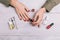 Top view of a woman doing a manicure and paint nails with red la