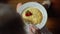 Top view of woman hands cutting piece of fried egg with knife and fork. Close up of eating fried eggs. Traditional