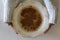 Top view of woman hands holding a vintage bowl with Oatmeal