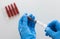 Top view of woman hands in medical gloves filling syringe barrel with vitamin group B for injection