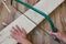 Top view of woman hands sawing a wooden plank indoors