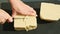 Top view on woman hands slice by knife big cubes of white marzipan mass