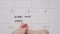 Top view of woman hands writing start diet again in calendar and then deleting it using a black pen -