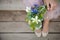 Top view on woman holding beautiful bunch of spring flowers. Girl with bouquet of daffodils,apple tree flowers and other