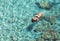 Top view of woman swimming at Milos, in Greece